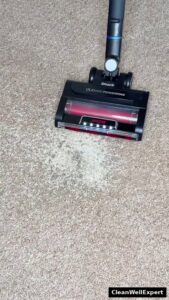 Real-world debris pickup test with the Shark Stratos cordless stick vacuum on low-pile carpet