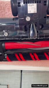 Underside view of the Shark Stratos floor nozzle revealing the dual-roller system with a soft front roller and silicone PowerFins
