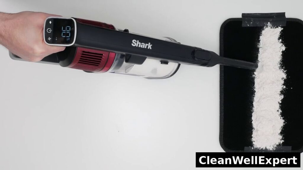 Top-down view of the Shark Vertex Pro IZ662H cordless vacuum testing fine dust pickup