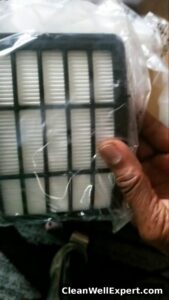 Side-by-side comparison of white foam pre-motor filter and black-framed pleated cartridge HEPA filter in packaging showing different filter types for Shark vacuums