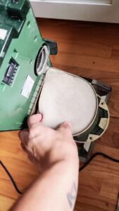 Removing packed foam pre-motor filter from Shark vacuum to fix overheating