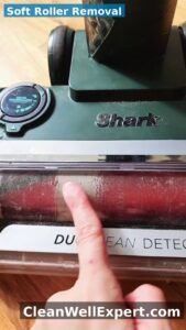 Removing Shark DuoClean Detect soft roller by sliding eject button on floor nozzle side - soft orange and black roller lifted out