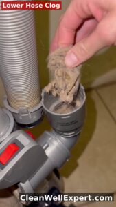 Shark Navigator vacuum airway blockage - large clump of hair and dust clogging the intake opening behind dust cup